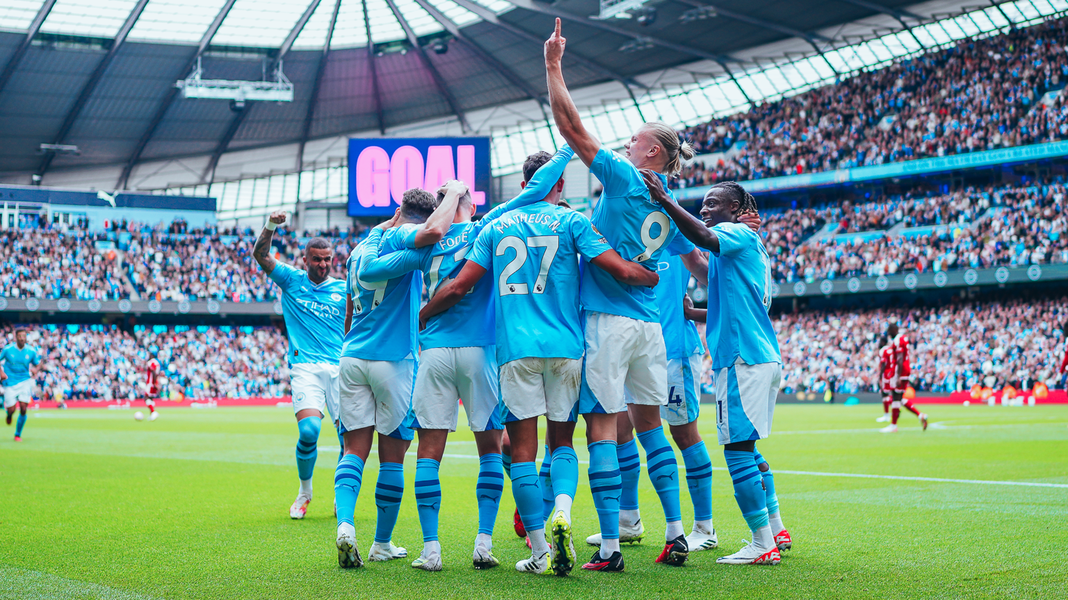 Manchester City fans at Etihad Stadium using $CITY fan token app for AR player stats overlay and cashless concessions payments