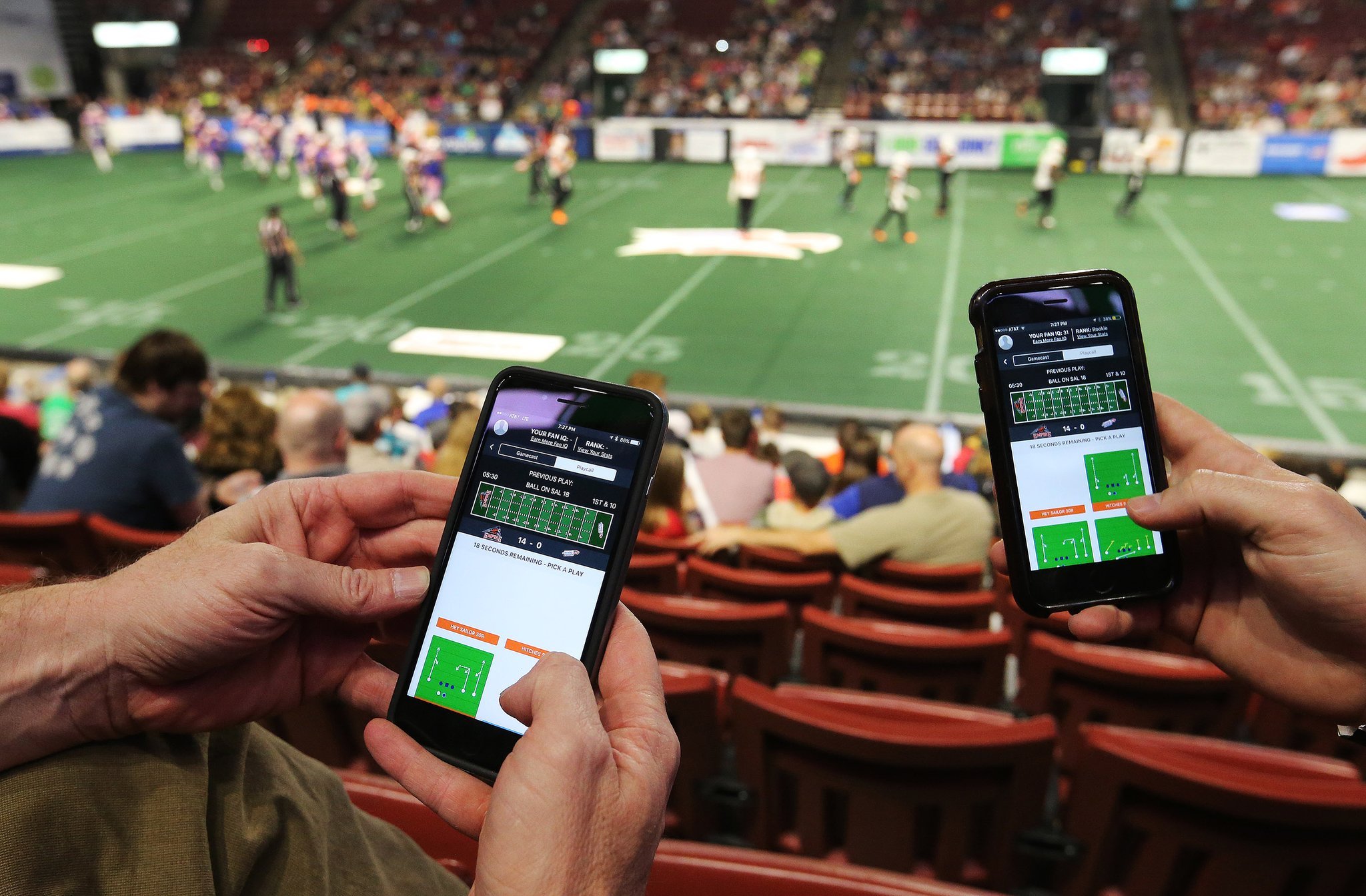Soccer fans in a stadium using mobile apps to trade fan tokens, capturing digital engagement and excitement during a match